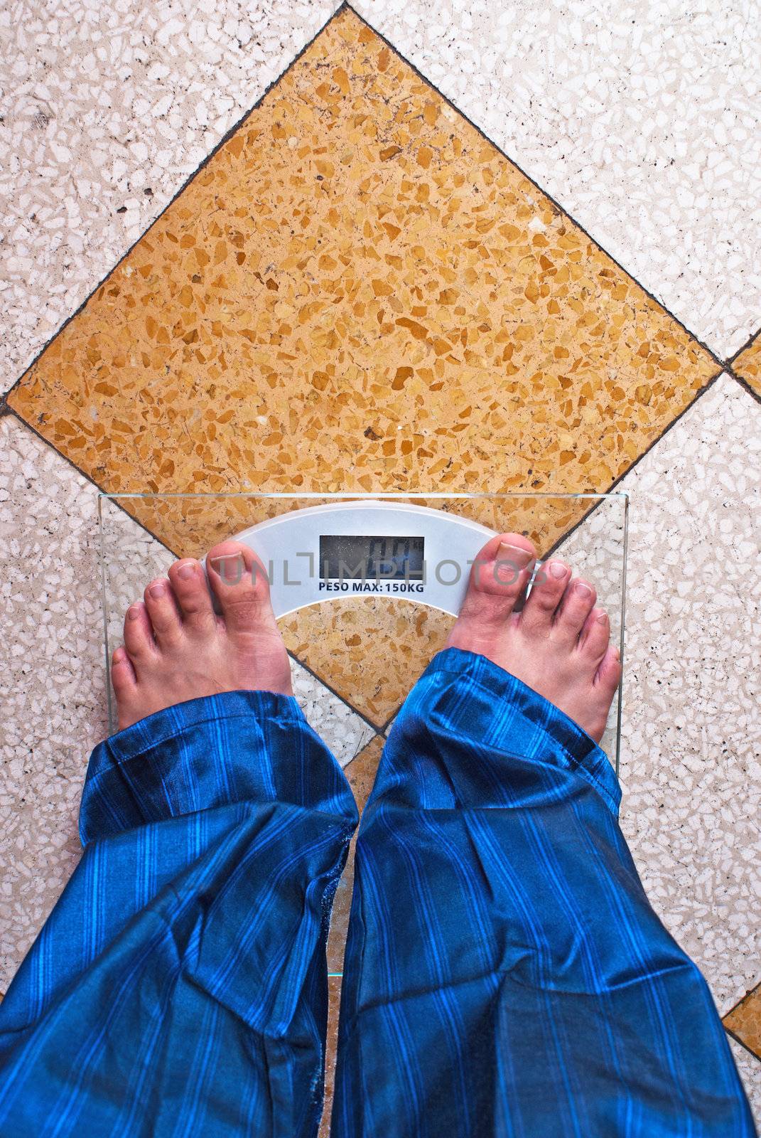 A scale with two feet of the person standing on it