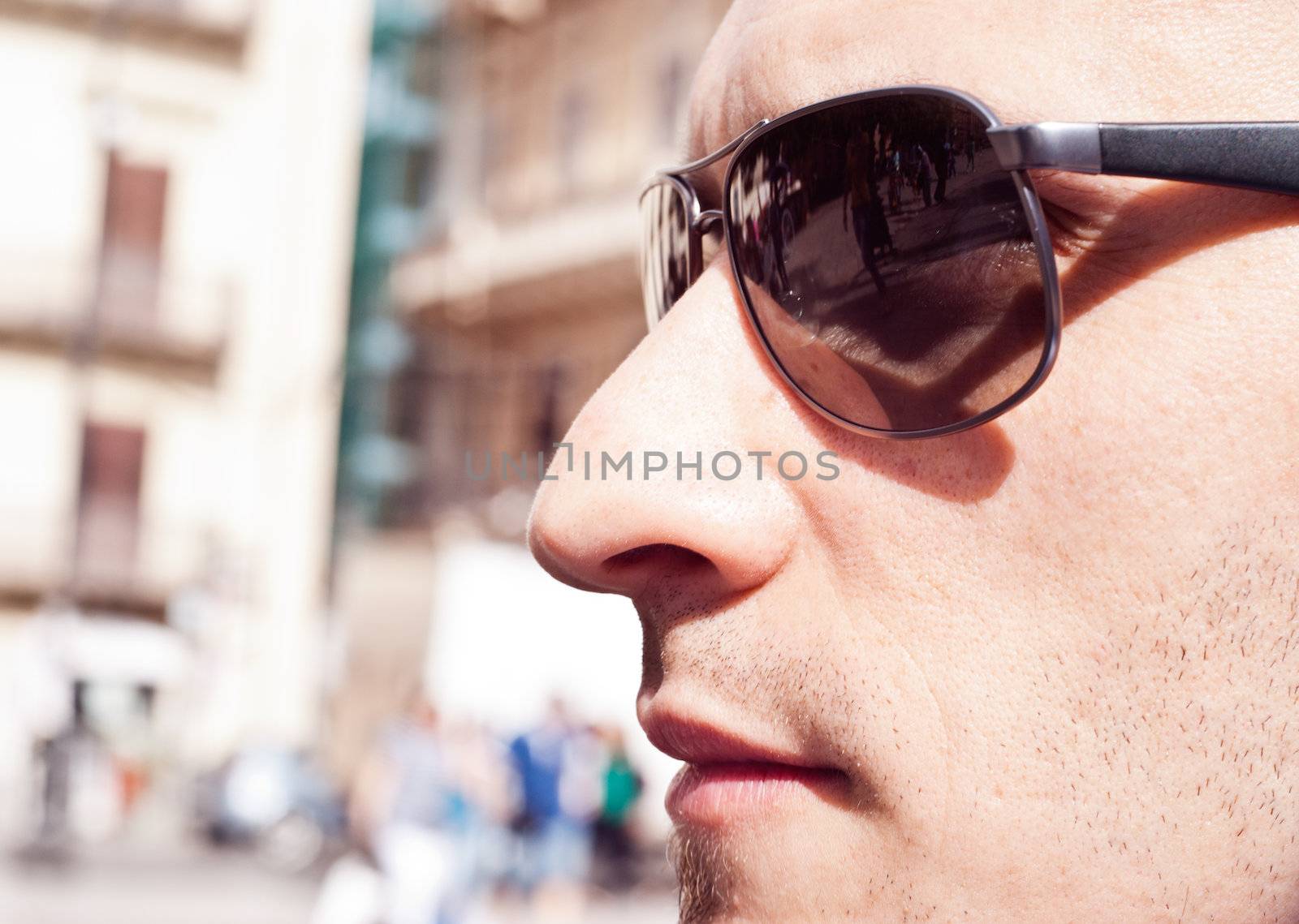 Close up handsome man. Profile - portrait of a attractive gorgeous guy wearing sunglasses, outdoor-park