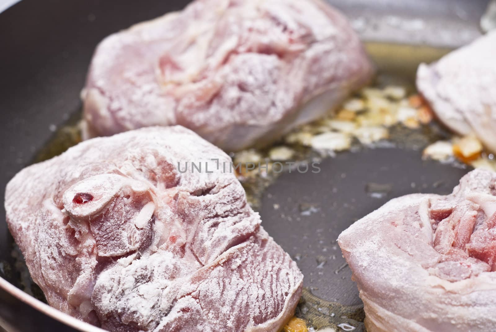Paesant food. floured osso buco in pan