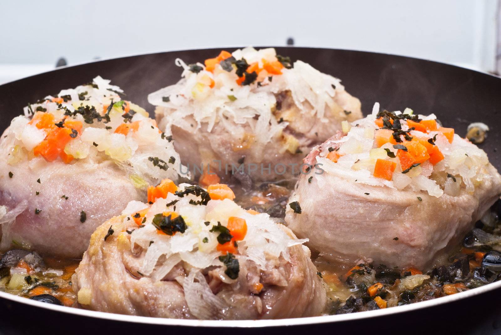 veal shank cooking in pan by gandolfocannatella