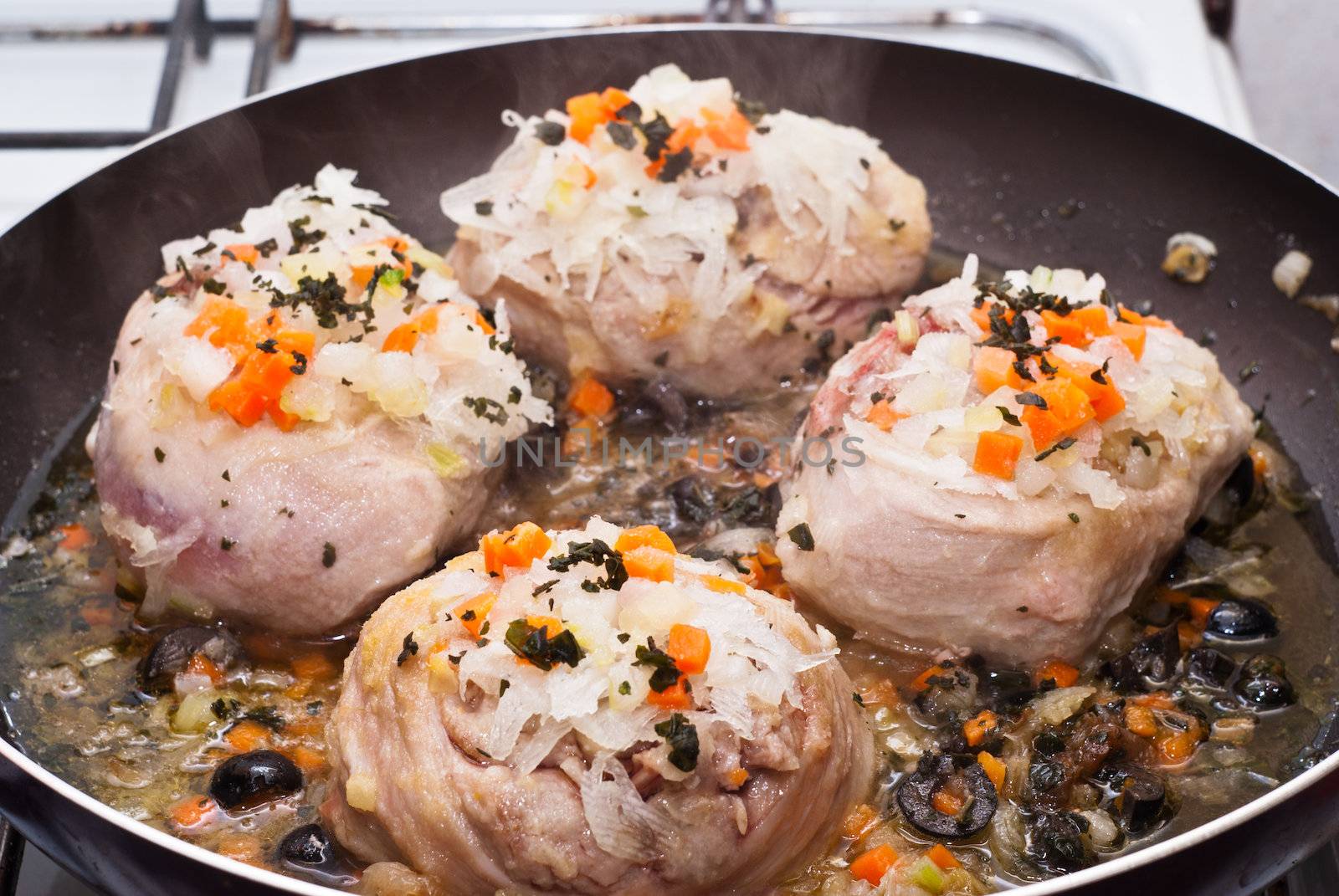 veal shank cooking in pan by gandolfocannatella