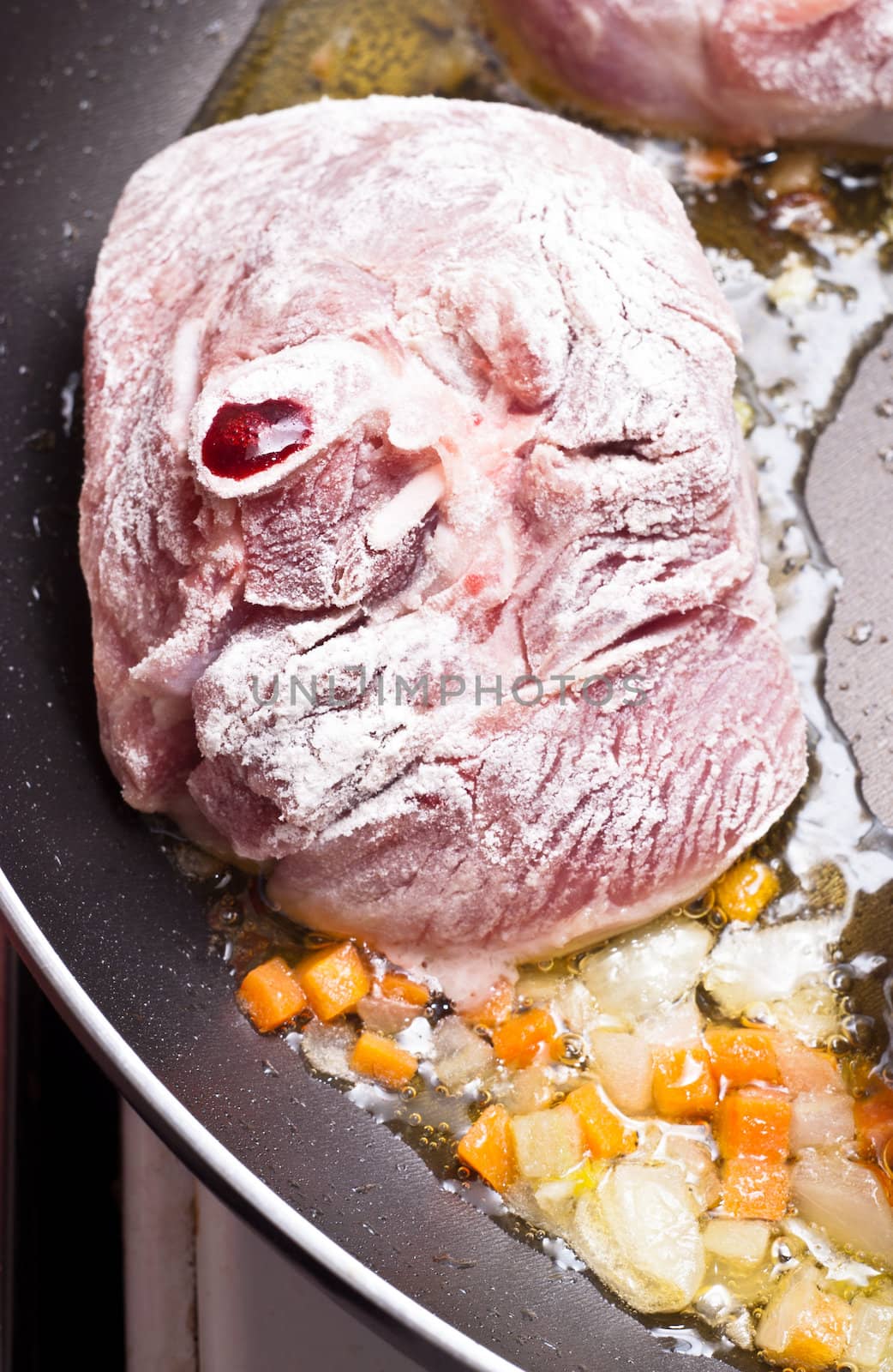 floured osso buco in pan by gandolfocannatella