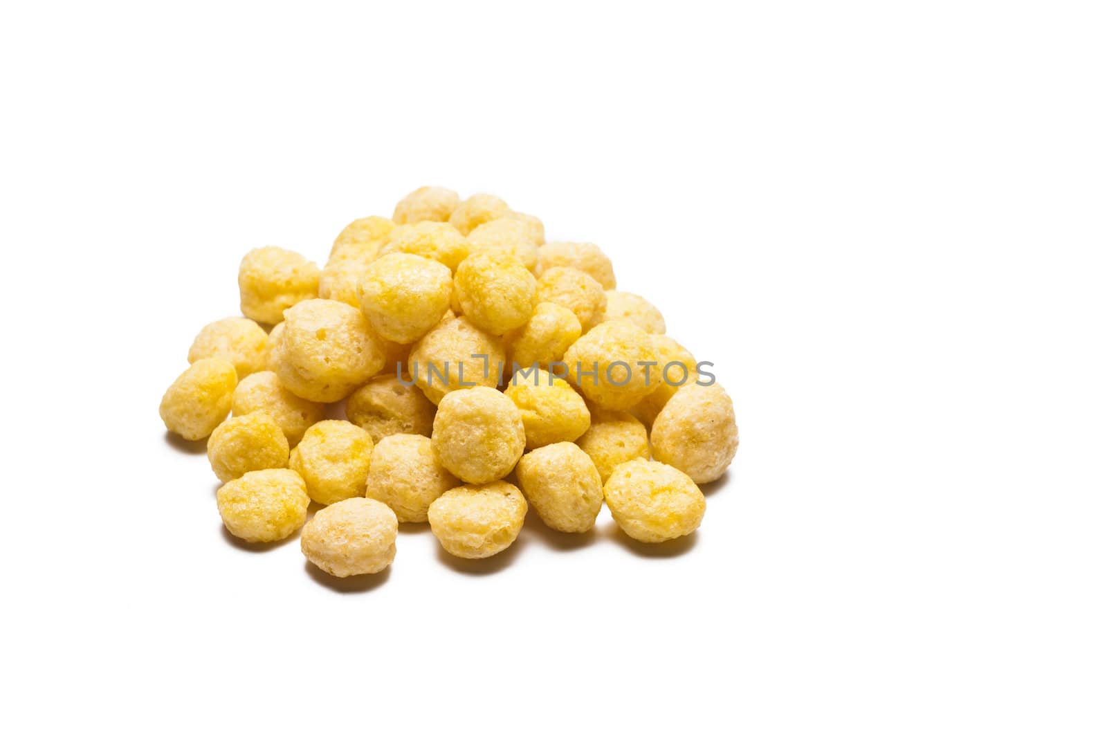 a pile of honey ball cornflakes on withe background