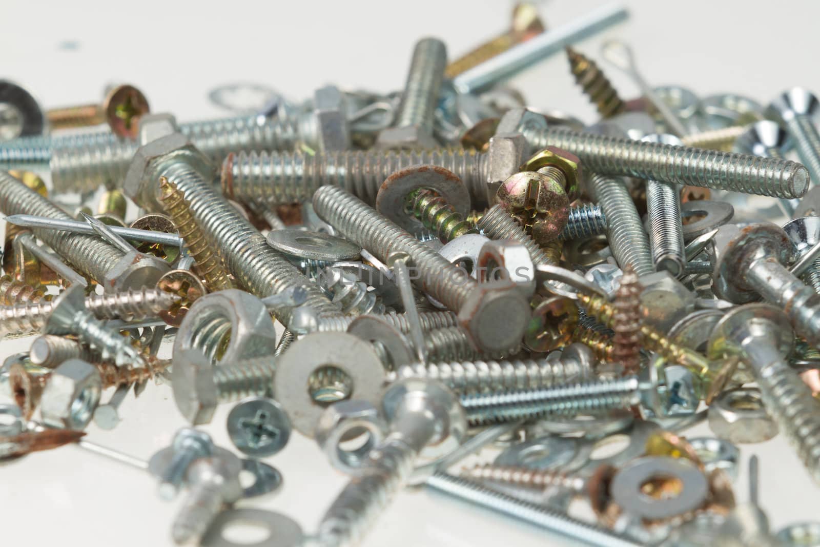 Screws, nuts, and bolts on isolated white background