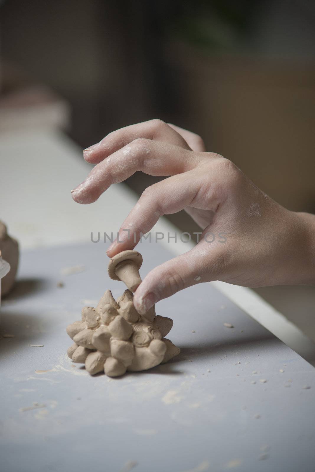 Girl make toyfrom clay. High resolution image.