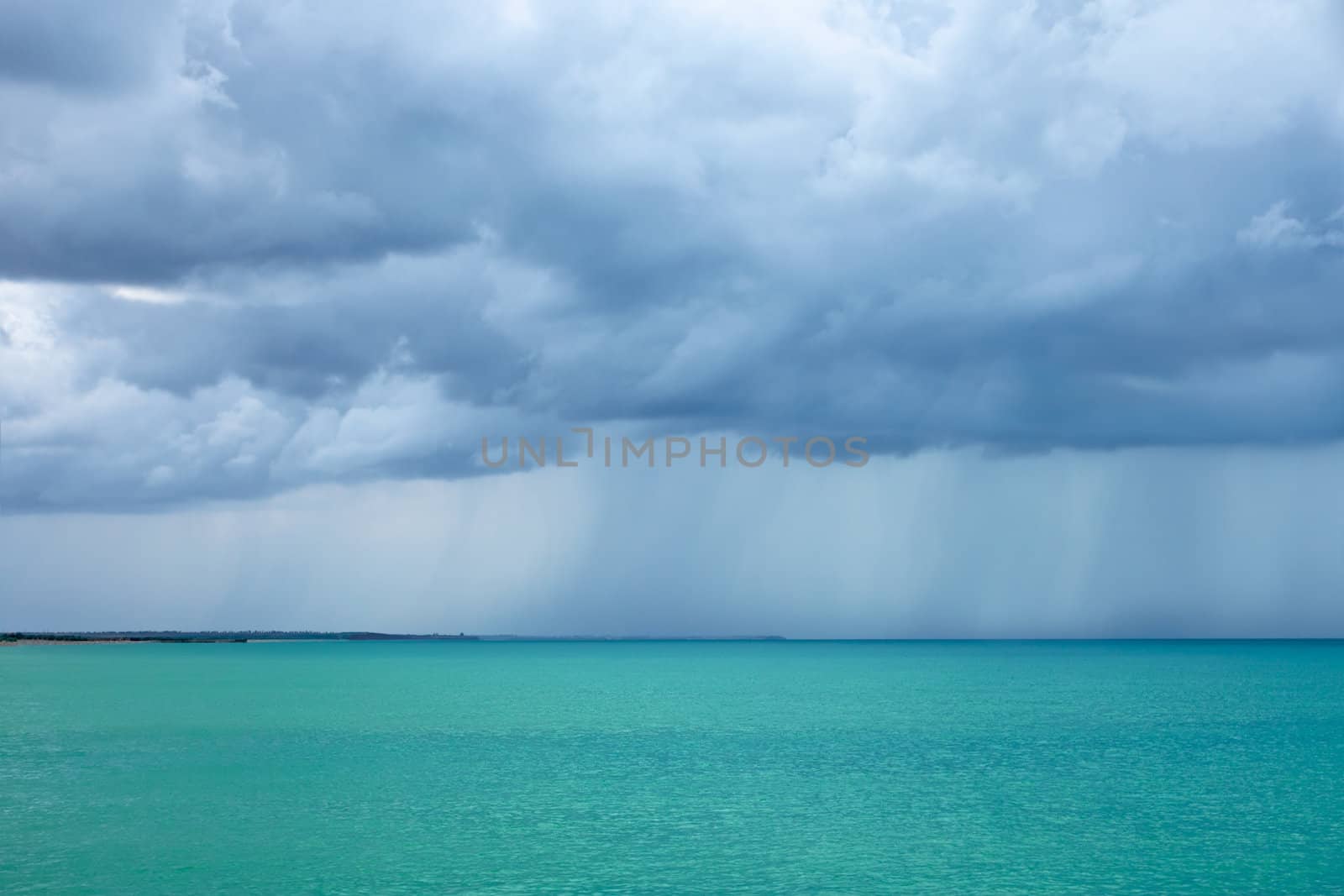 Cumulonimbus clouds over the turquoise sea by qiiip