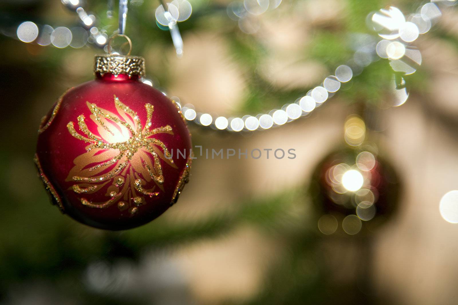 Christmas red bow and beads on  background of fir