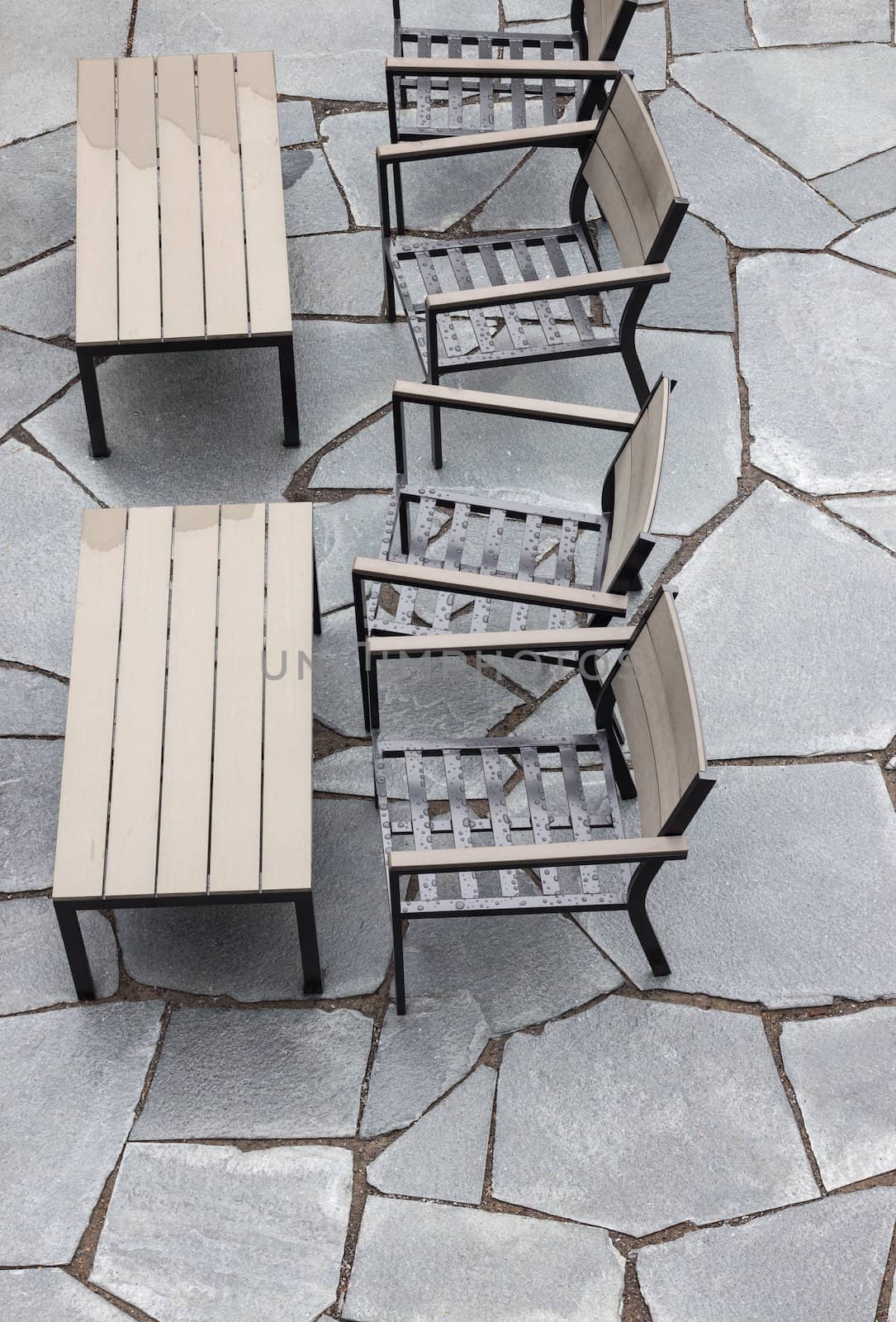 Outdoor cafe after the rain, rain drops on the chairs.