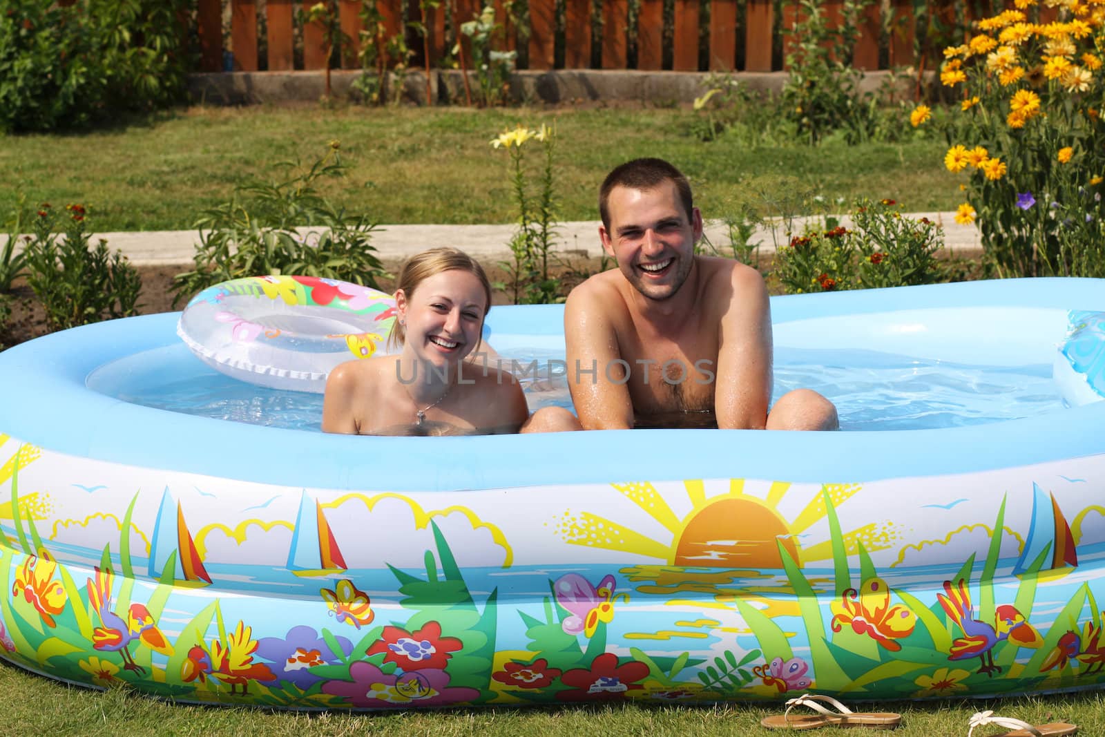 young pair bathes in inflatable pool