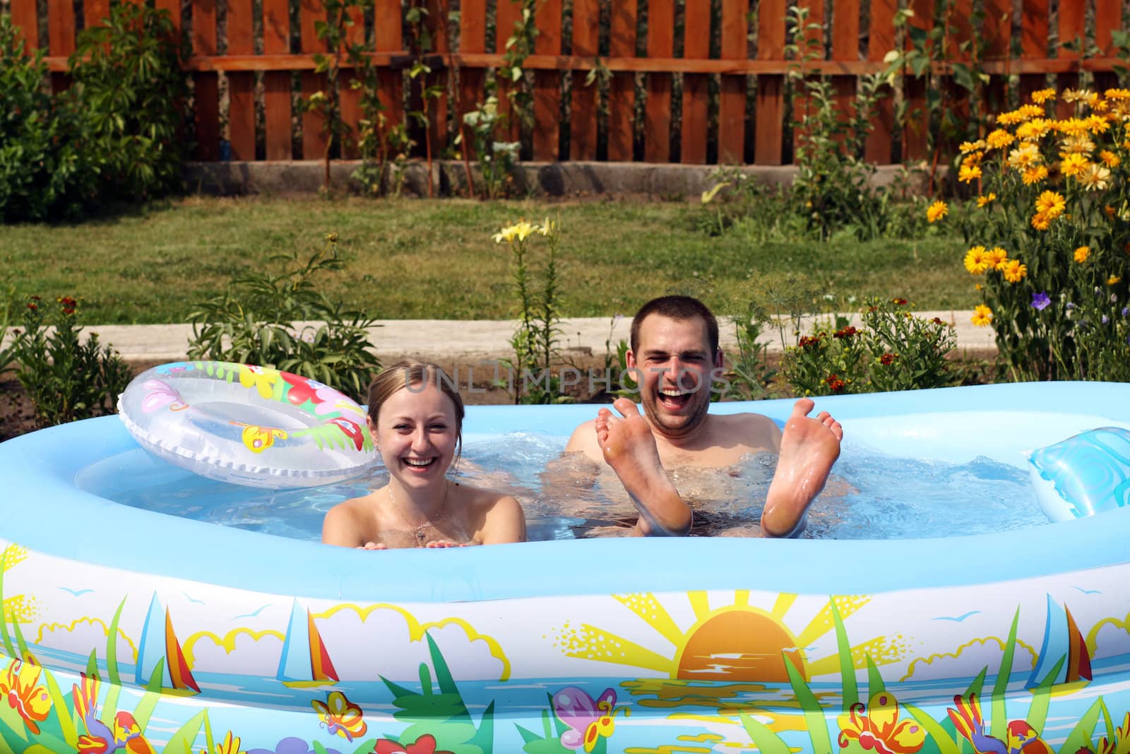 young pair bathes in inflatable pool