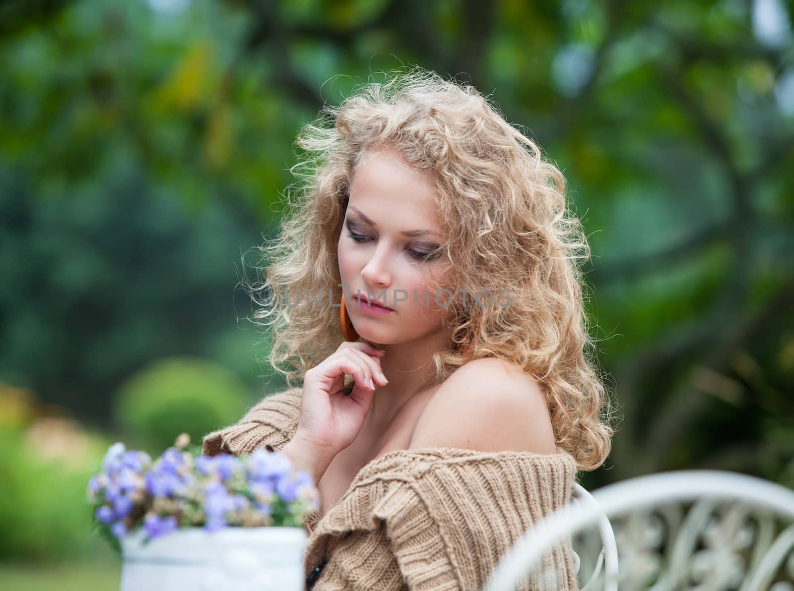 young beautiful woman is resting in the garden