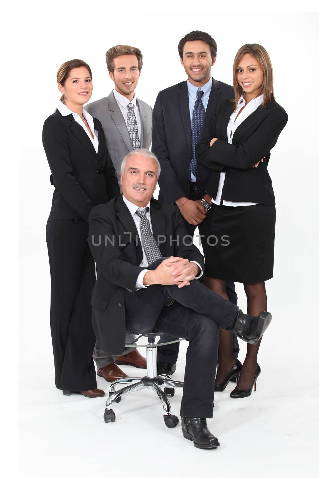 Young business team standing behind their boss by phovoir