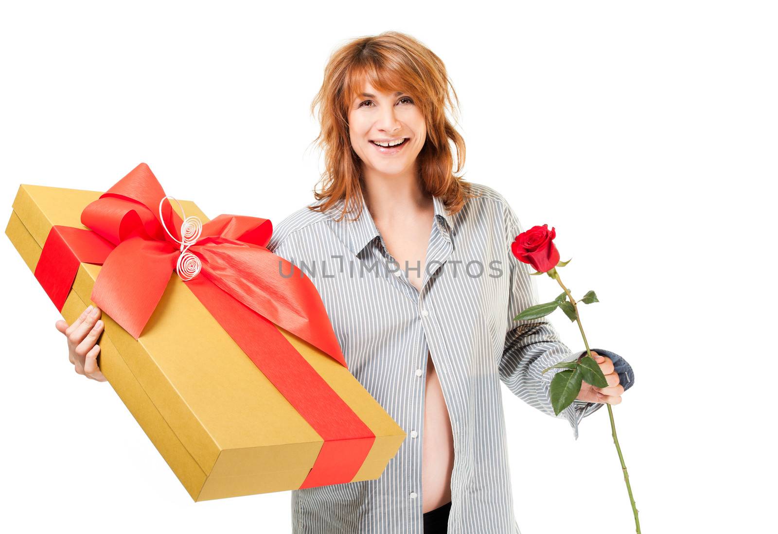 Beautiful smiling pregnant woman with shirt holding present and rose, looking at camera