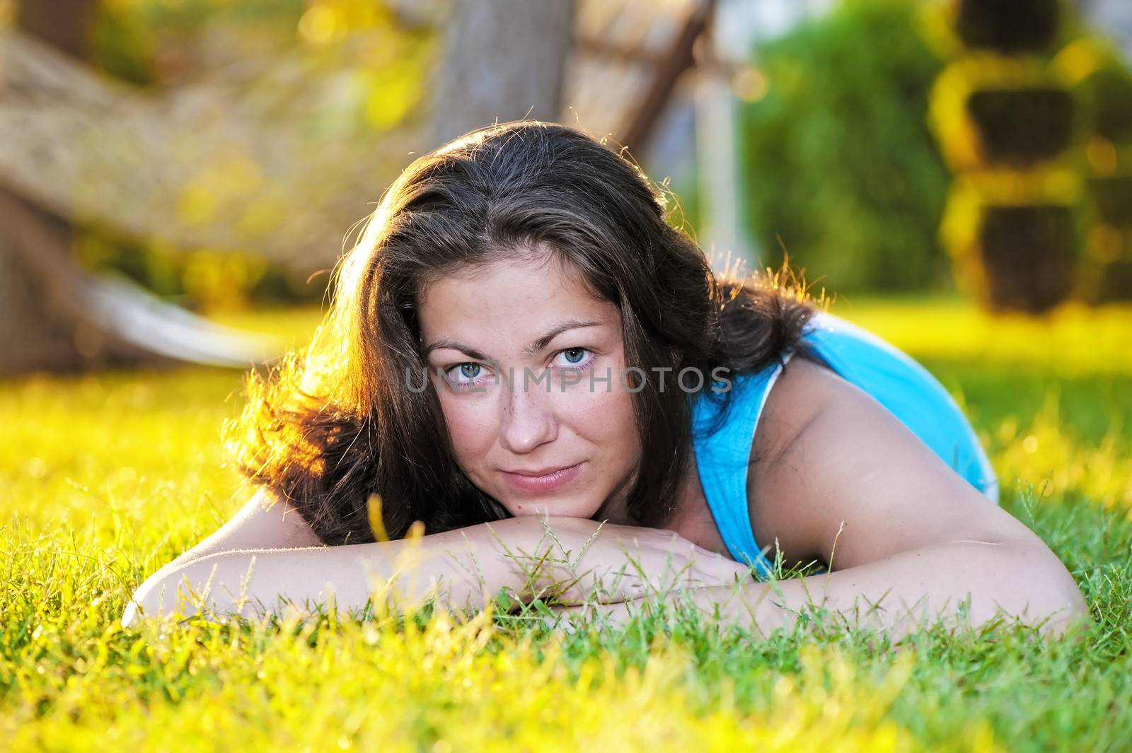 Brunette girl lying on the grass