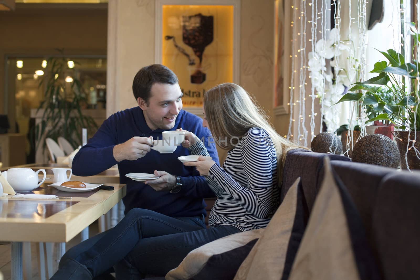 Couple lovers in caffe by andersonrise