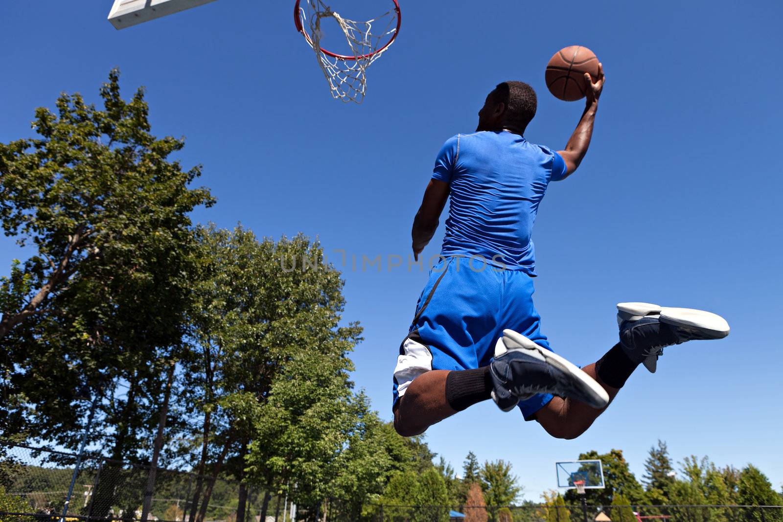 A young basketball player driving to the hoop with some fancy moves.