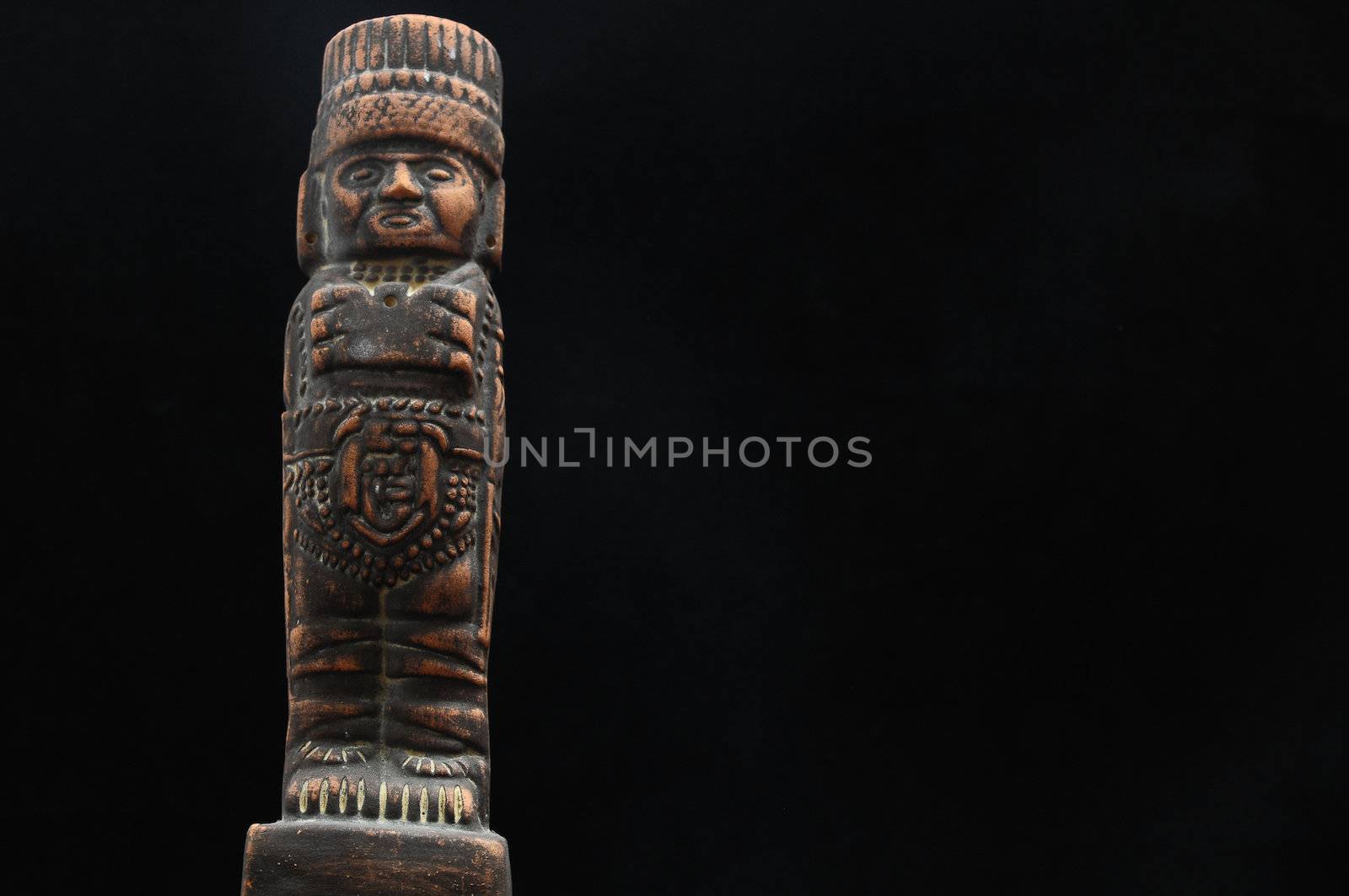 One Ancient Mayan Statue on a Black Background