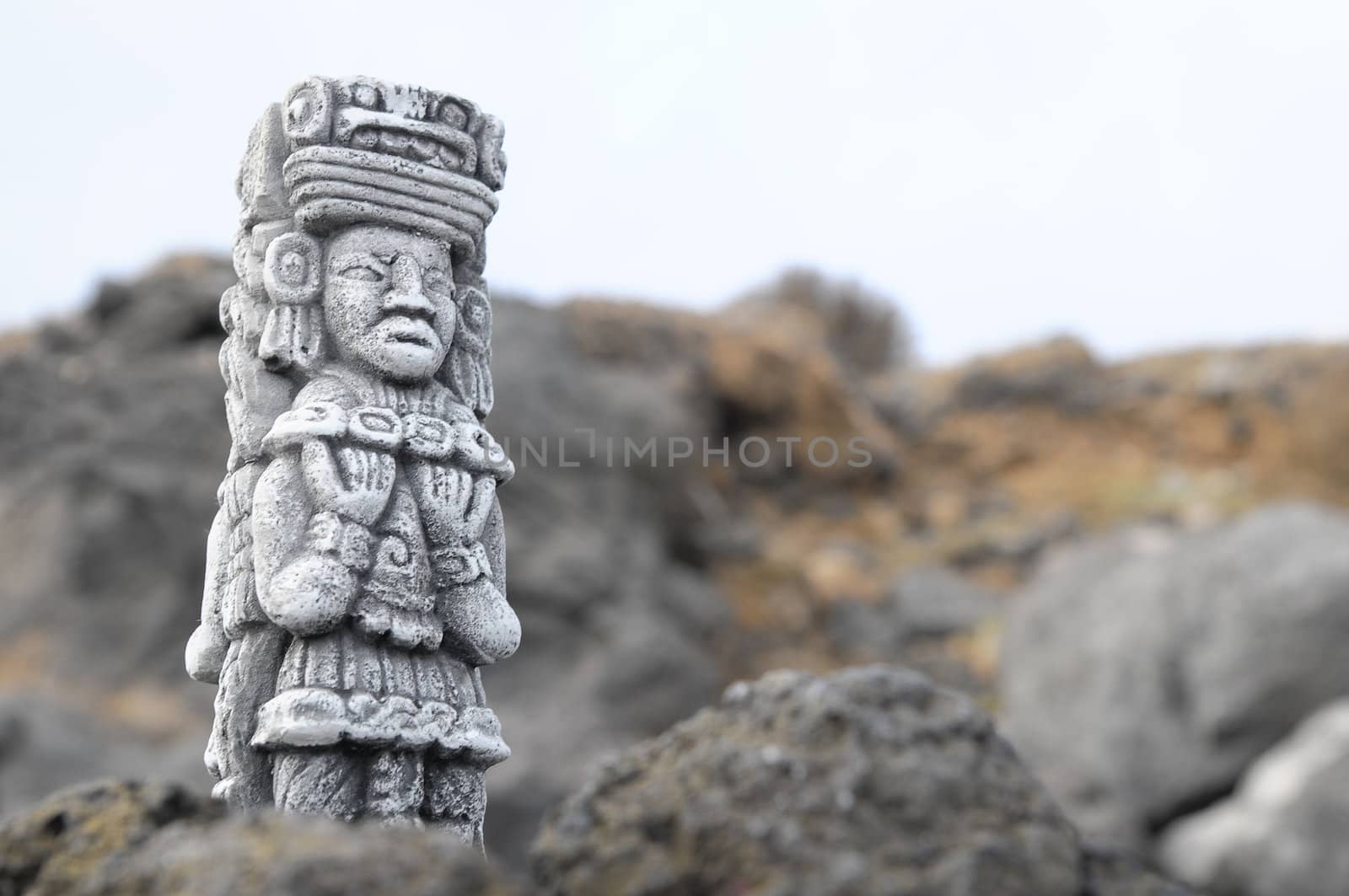 Ancient Maya Statue on the Rocks near the Ocean