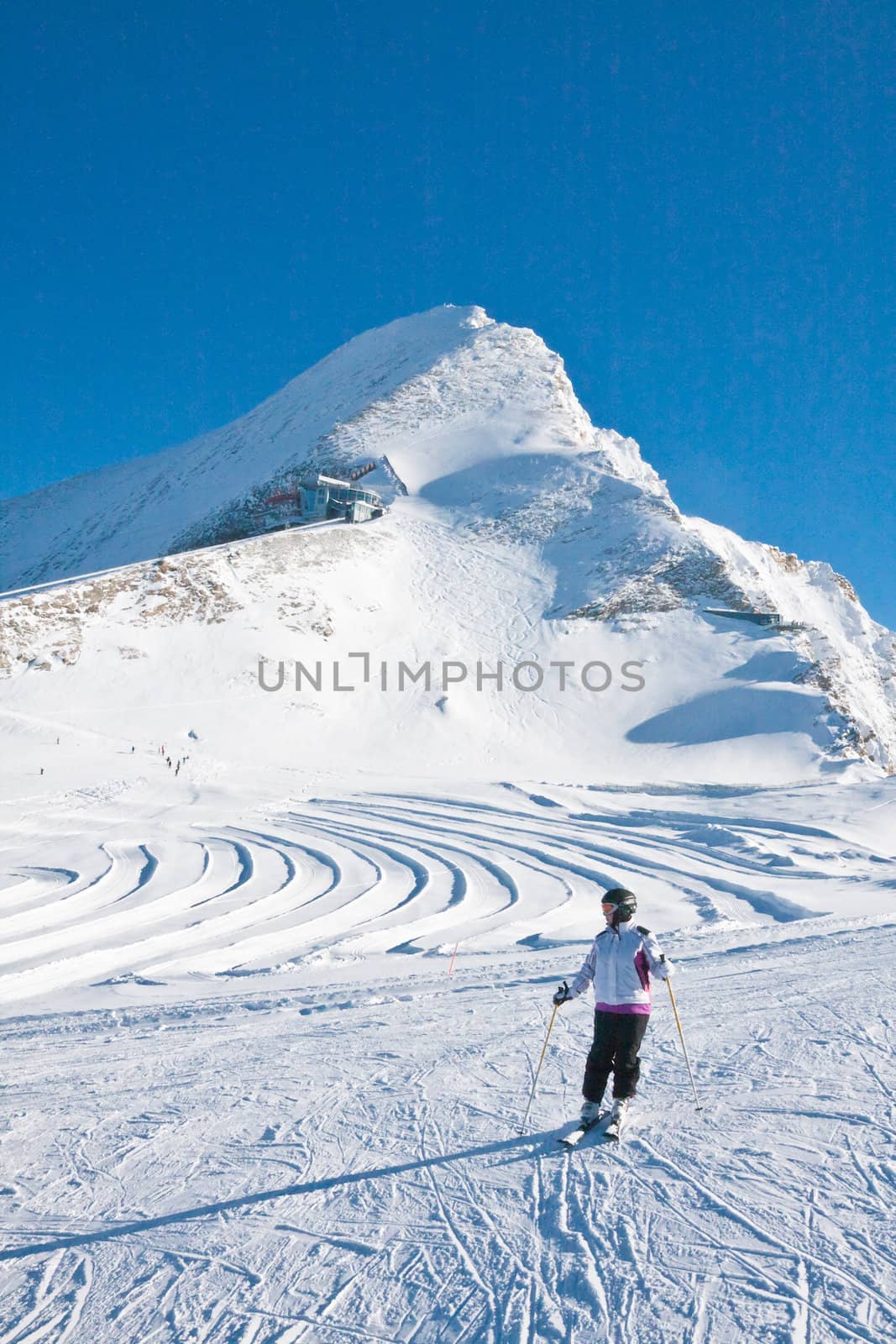 Ski resort of Kaprun, Woman and Kitzsteinhorn glacier. Austria