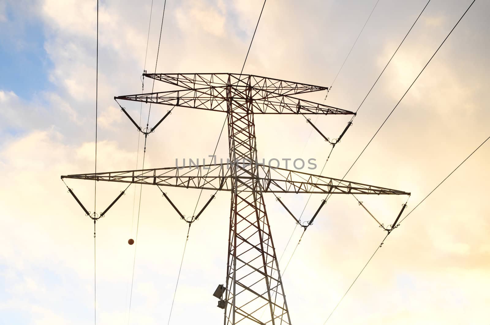 Power Electric Tower on a Cloudy Sky at Sunset