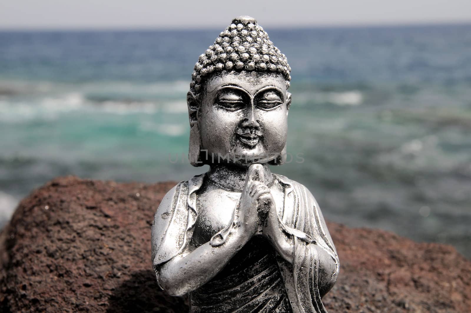 One Ancient Gray Buddha Statue Near The Ocean