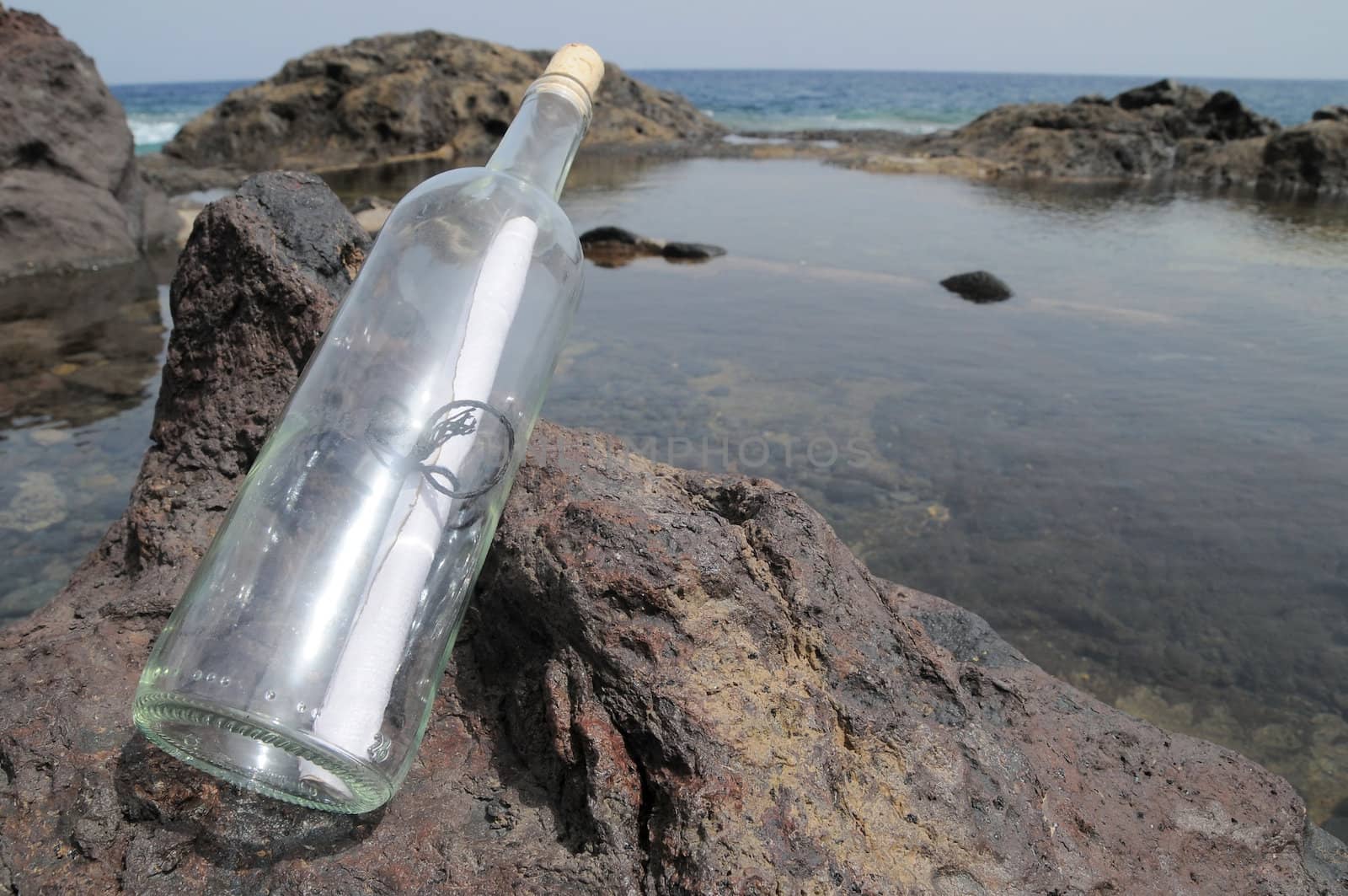 Message in the Bottle on the Rocks near the Beach