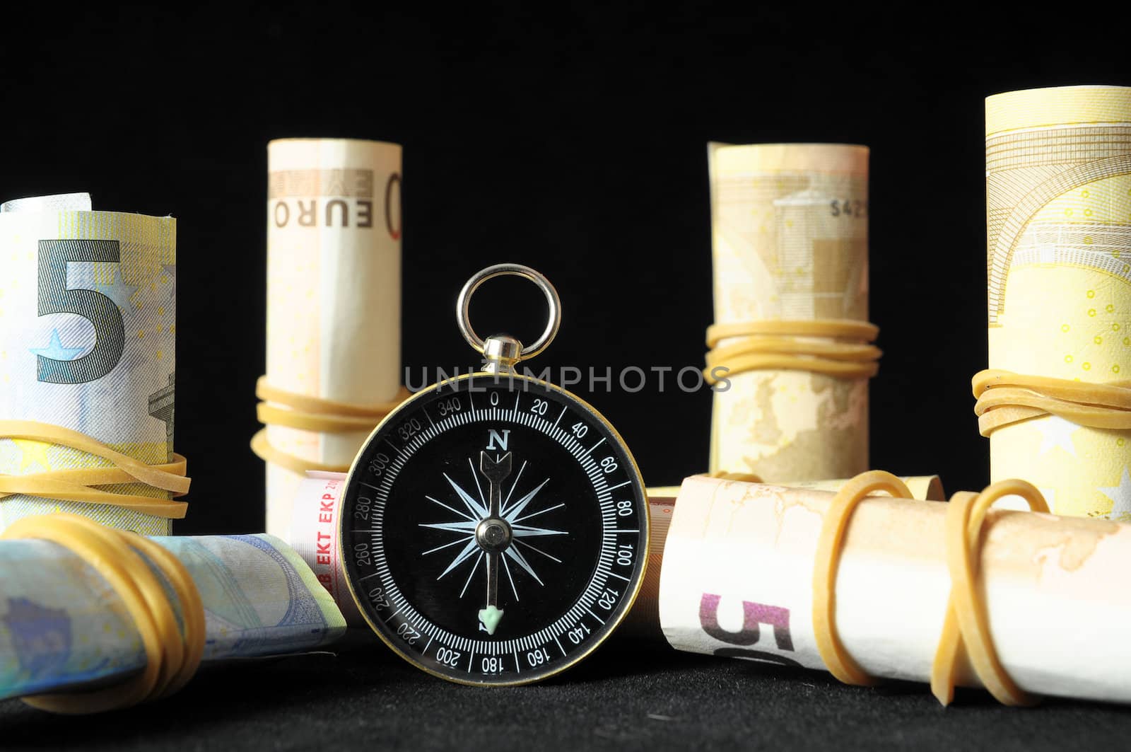 Orientation in  Business Compass and Money on a Black Background