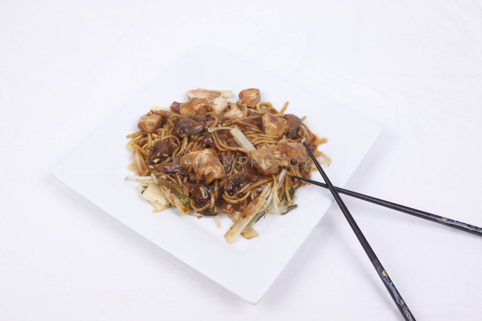 cooked noodles with pieces of chicken breast and vegetables in savoury mushroom sauce