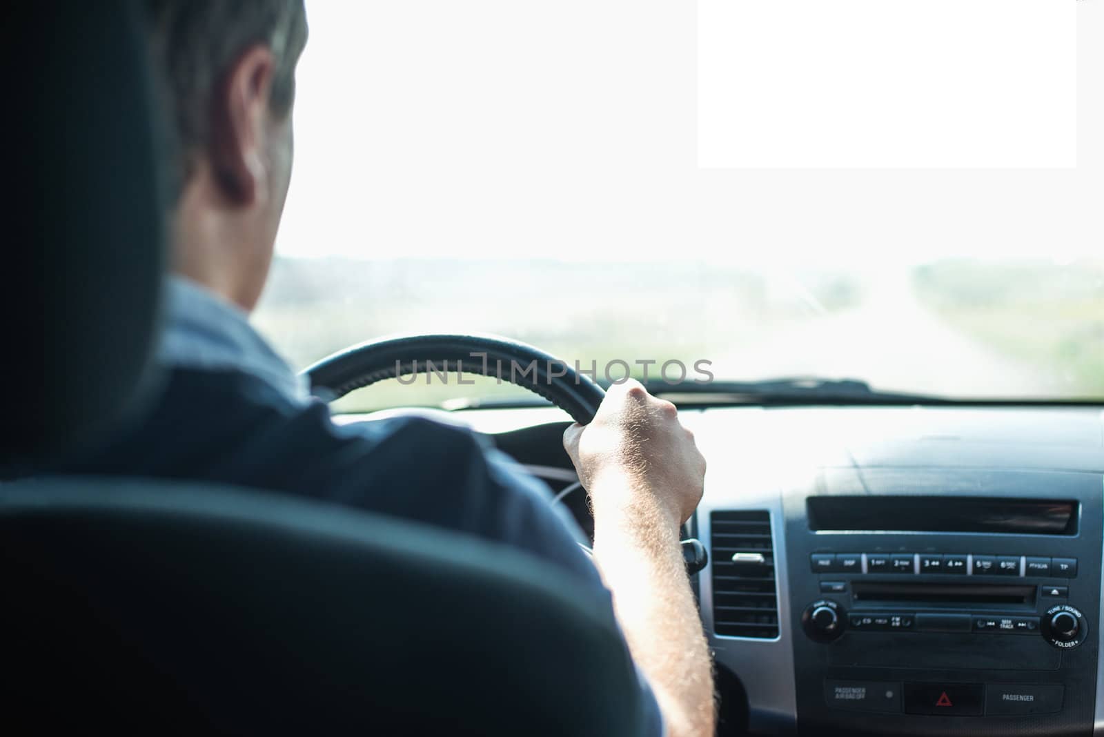 Hands of a driver on steering wheel of a car