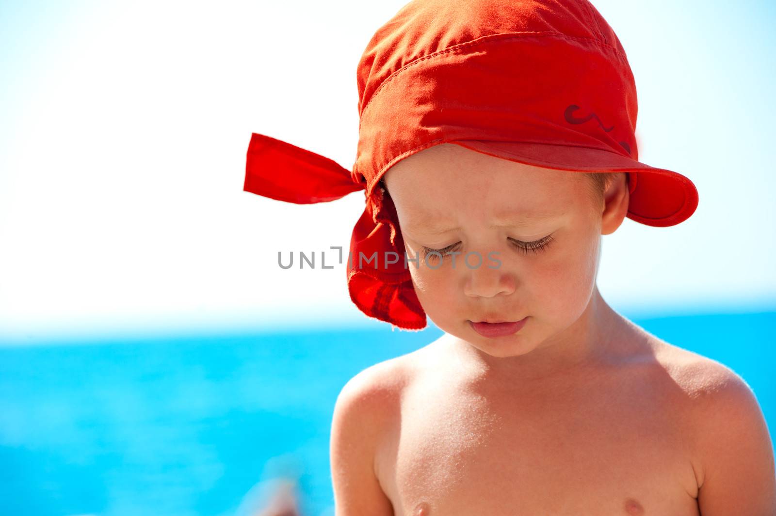 Thoughtful child on sea background by kosmsos111