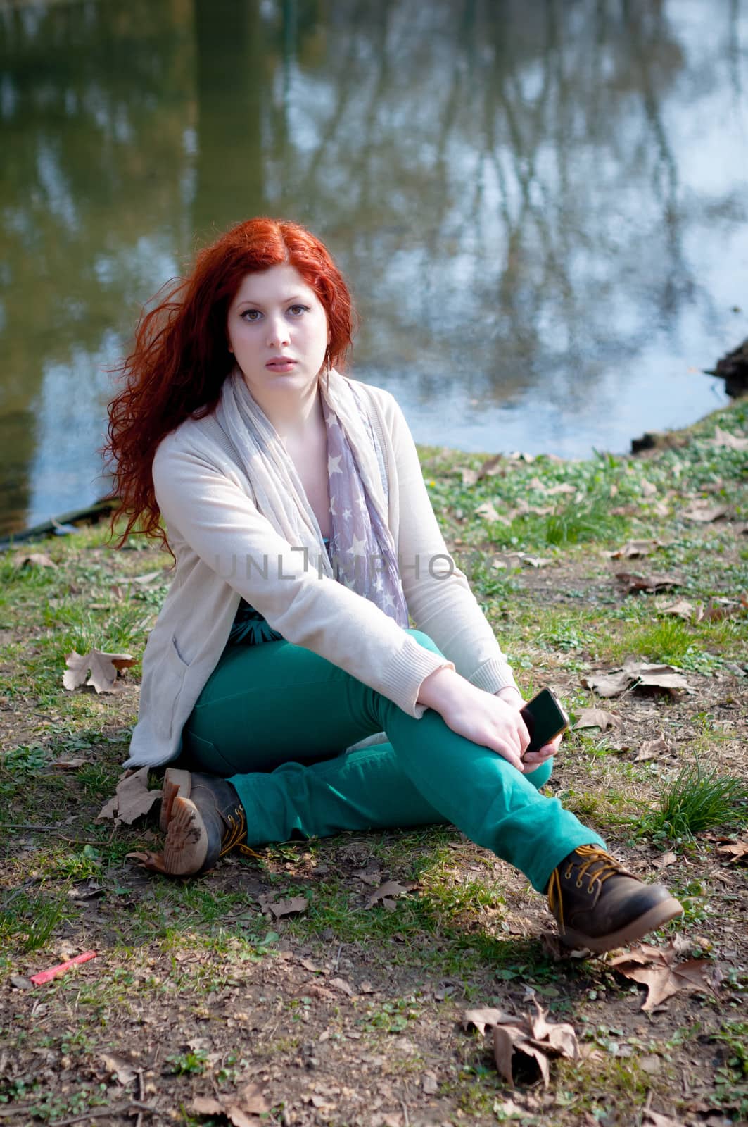 beautiful young woman posing in the park of the city