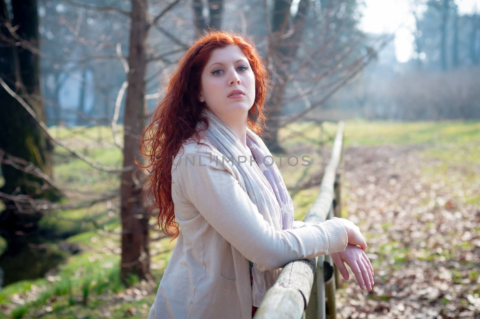 beautiful young woman posing in the park of the city
