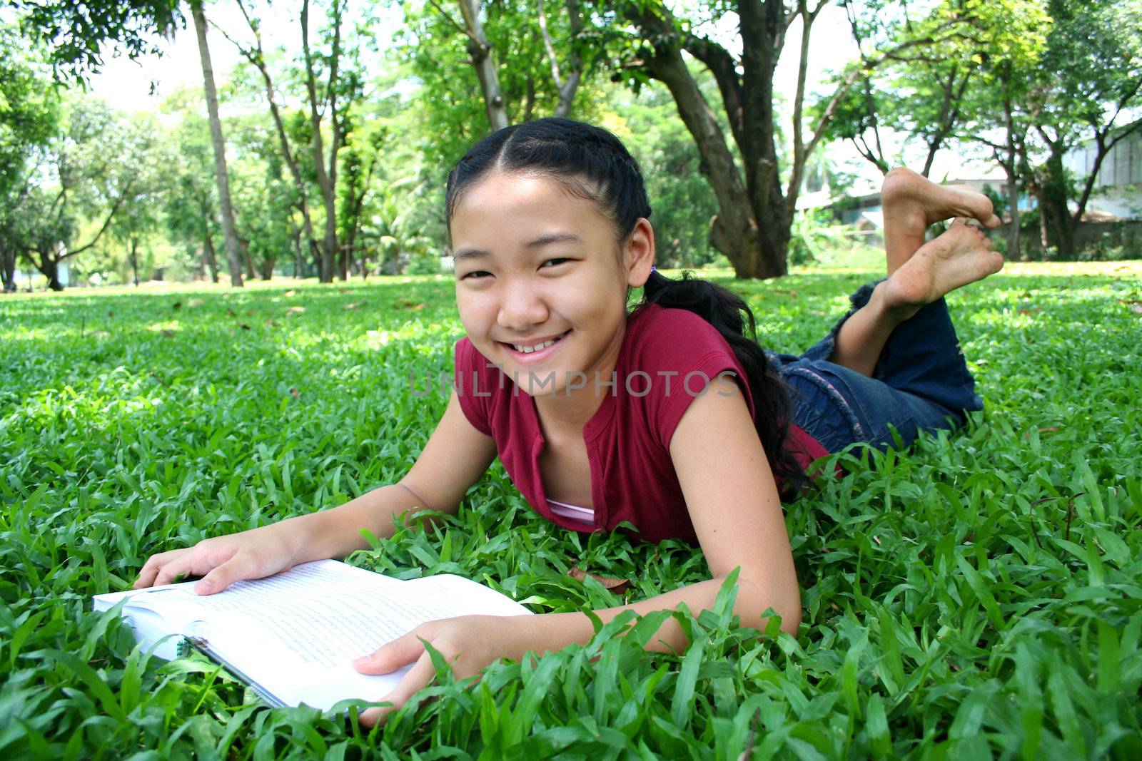 Girl in the park reading book