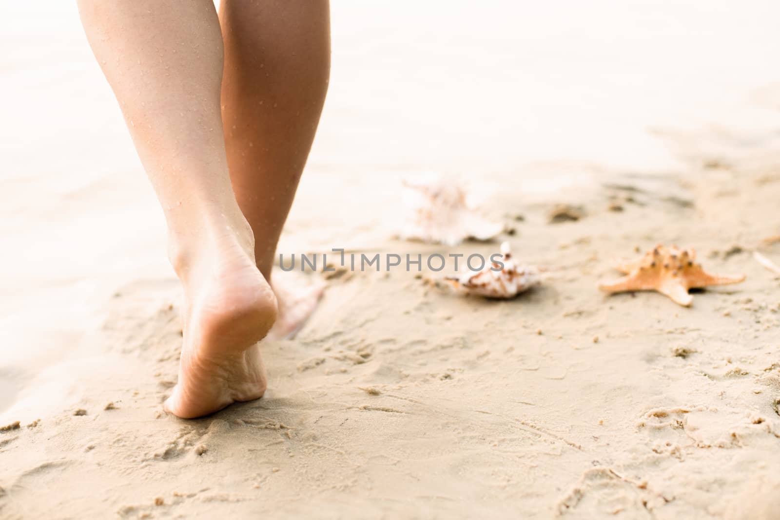 Beach travel - woman walking by Nickolya