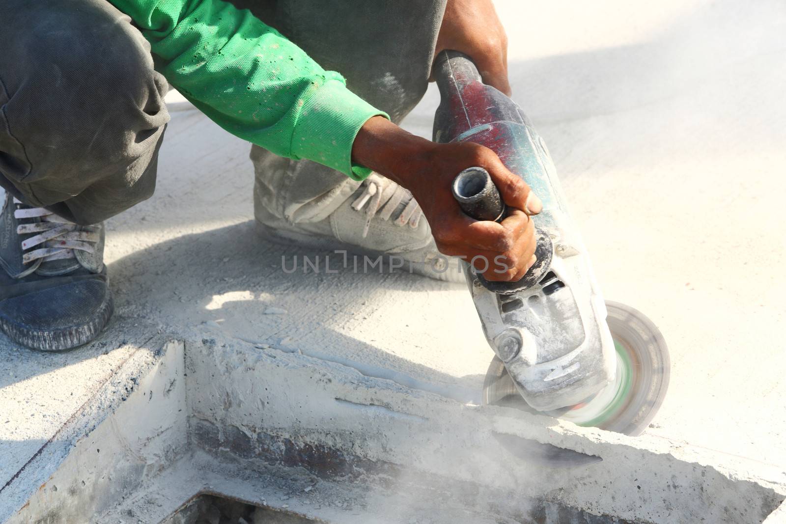 Worker use angle grinder to cut concrete