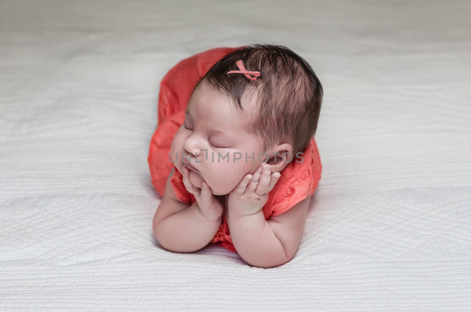 Beautiful newborn baby sleeping on her elbows and hands by doble.d