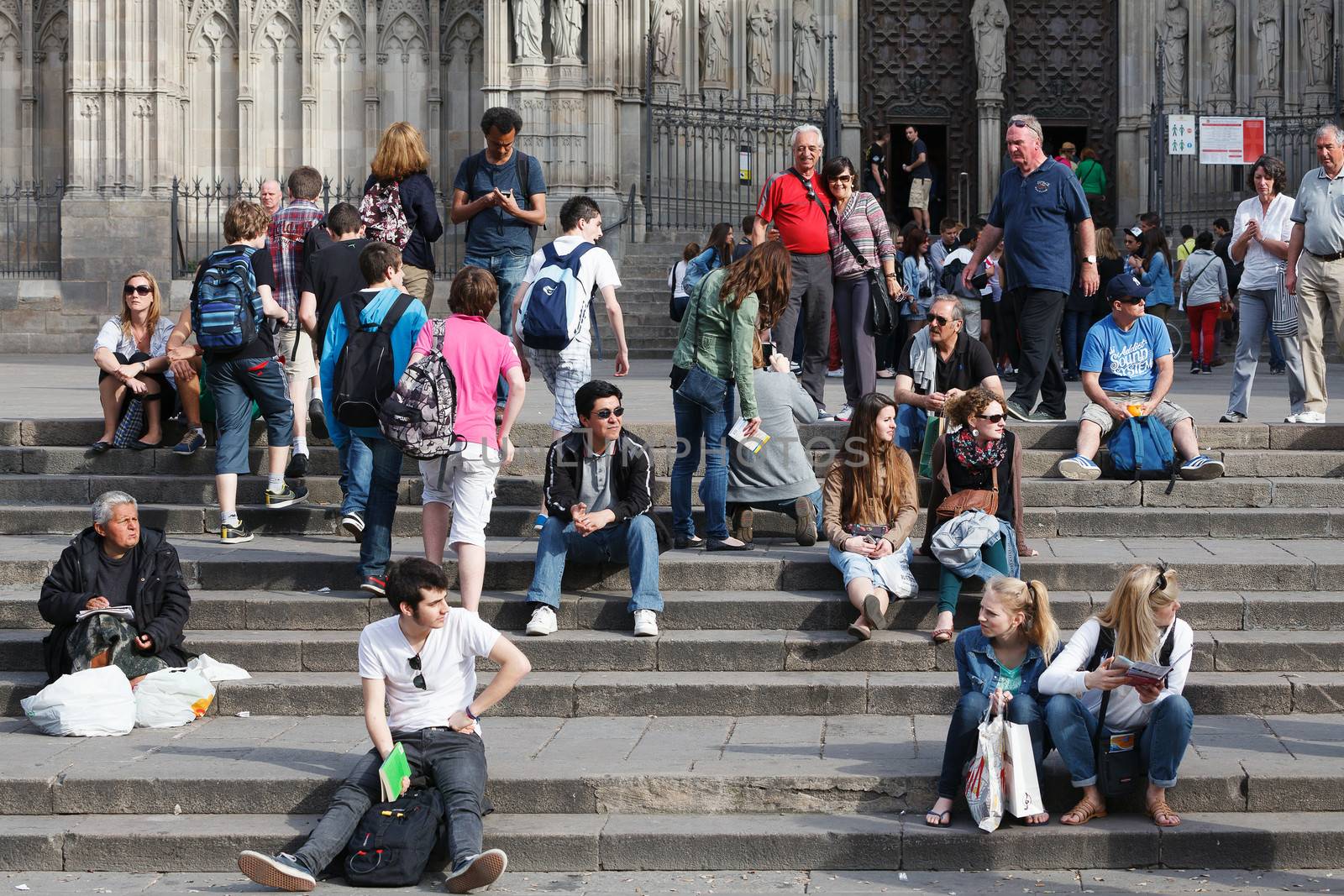 Tourists sit on the stairs of Barcelona Cathedral by Nobilior