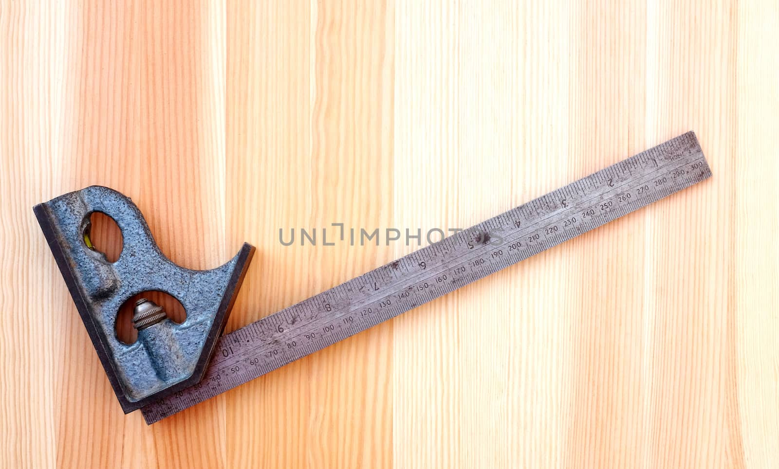 Metal set square on a wooden board