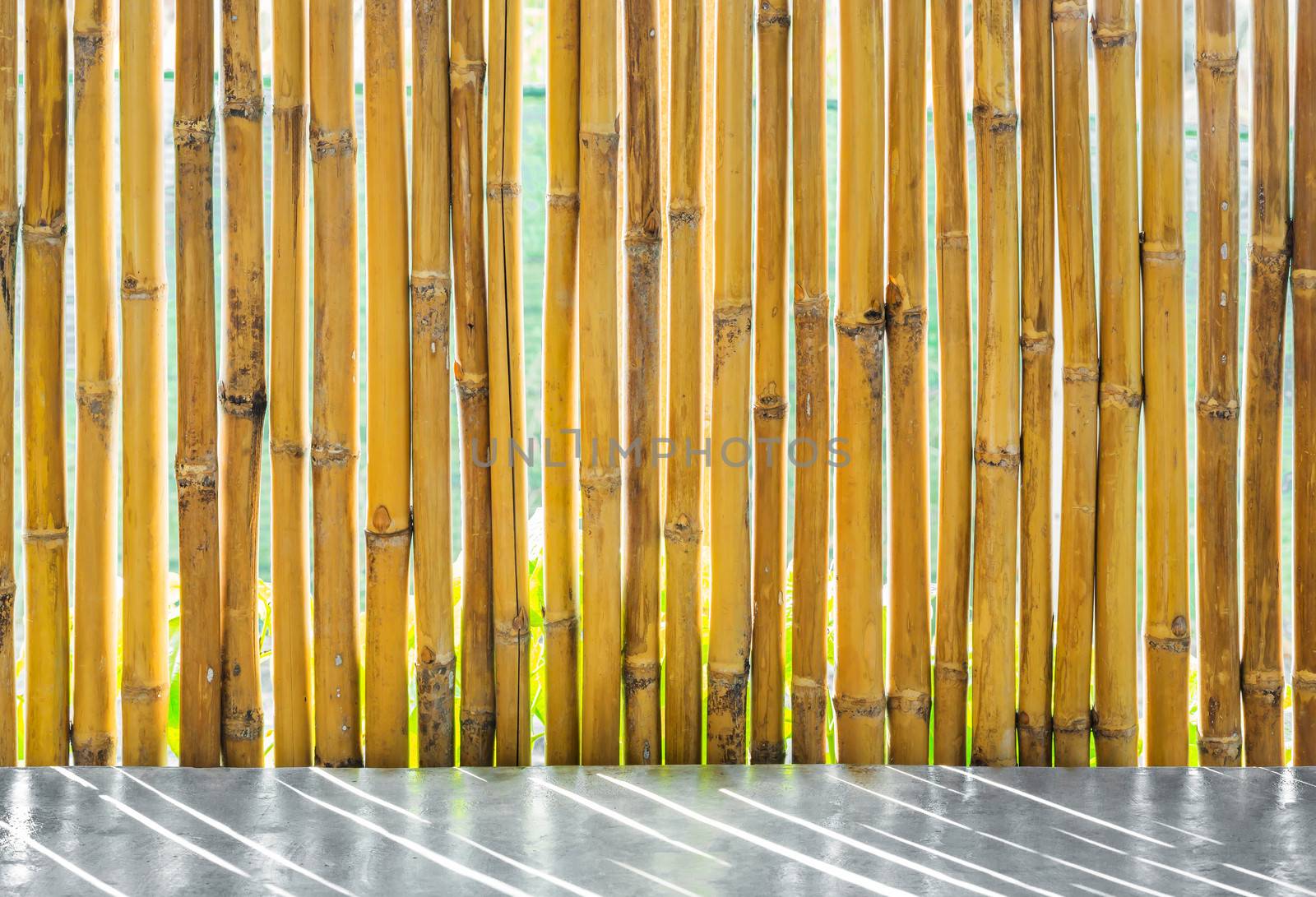 Yellow bamboo fence and concrete floor
