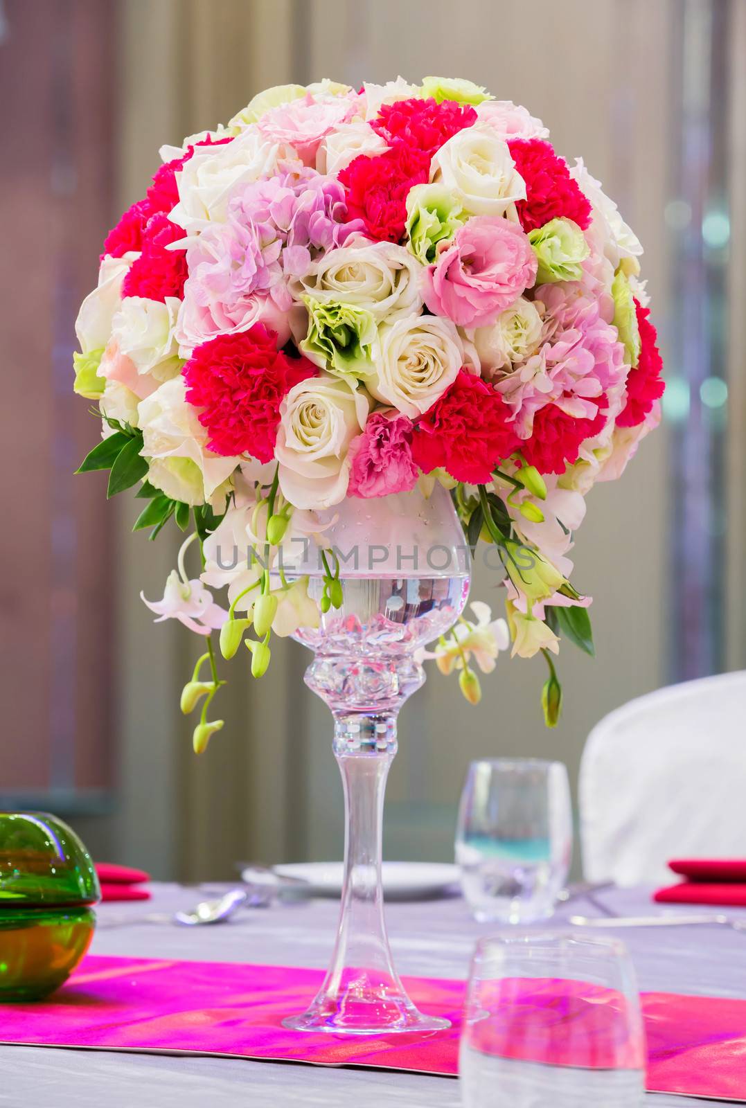Flower bouquet in glass vase on dining table