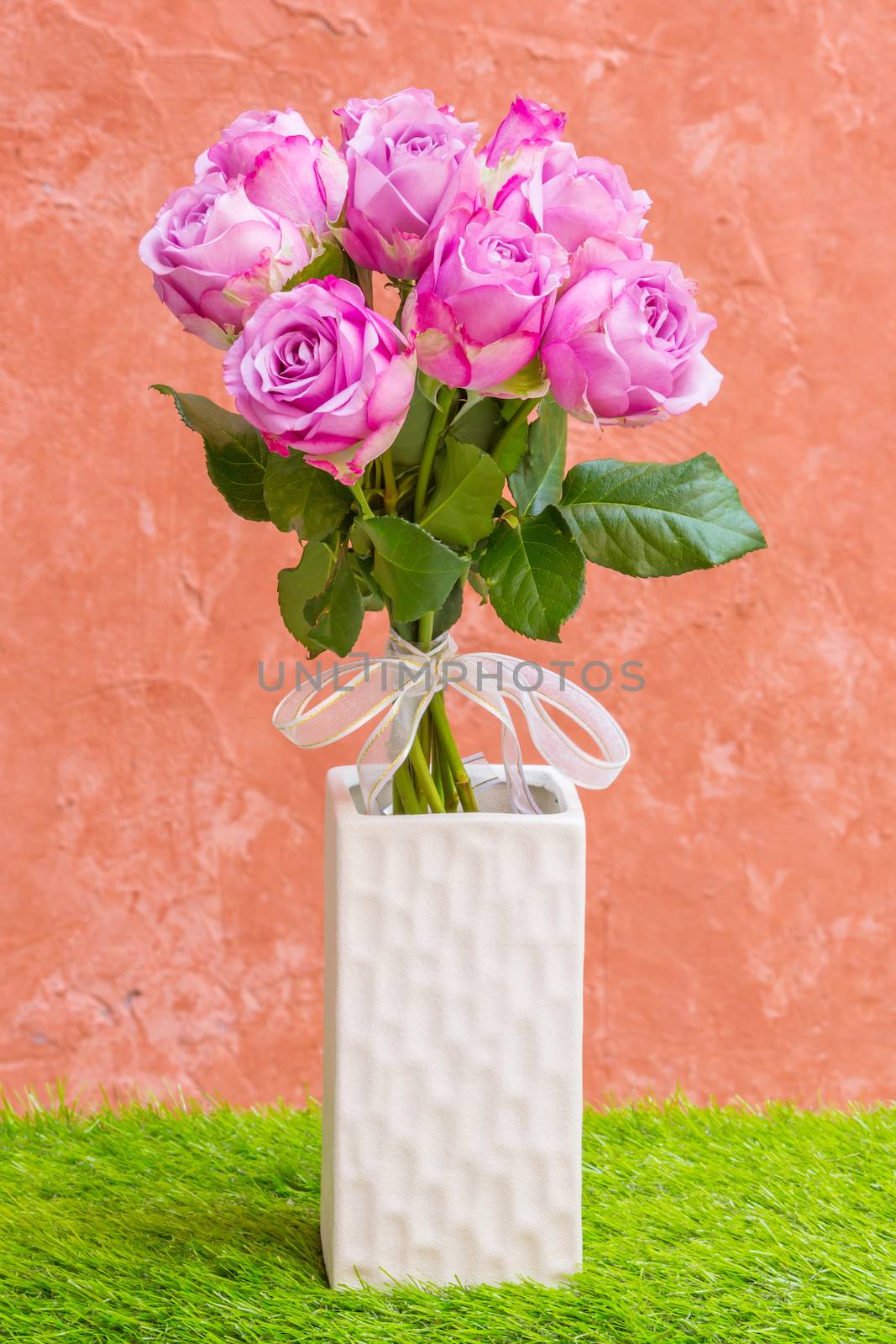 Violet rose in vase with white bow tie