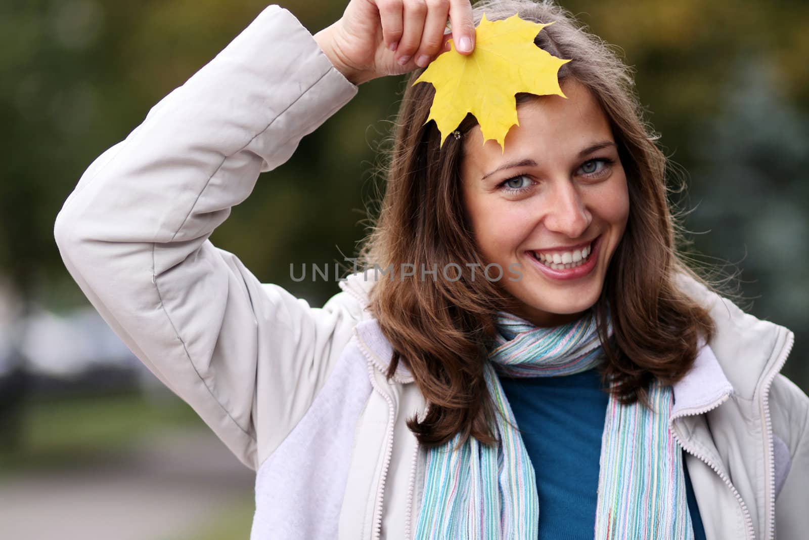 young beautiful woman with a bouquet of maple leaves