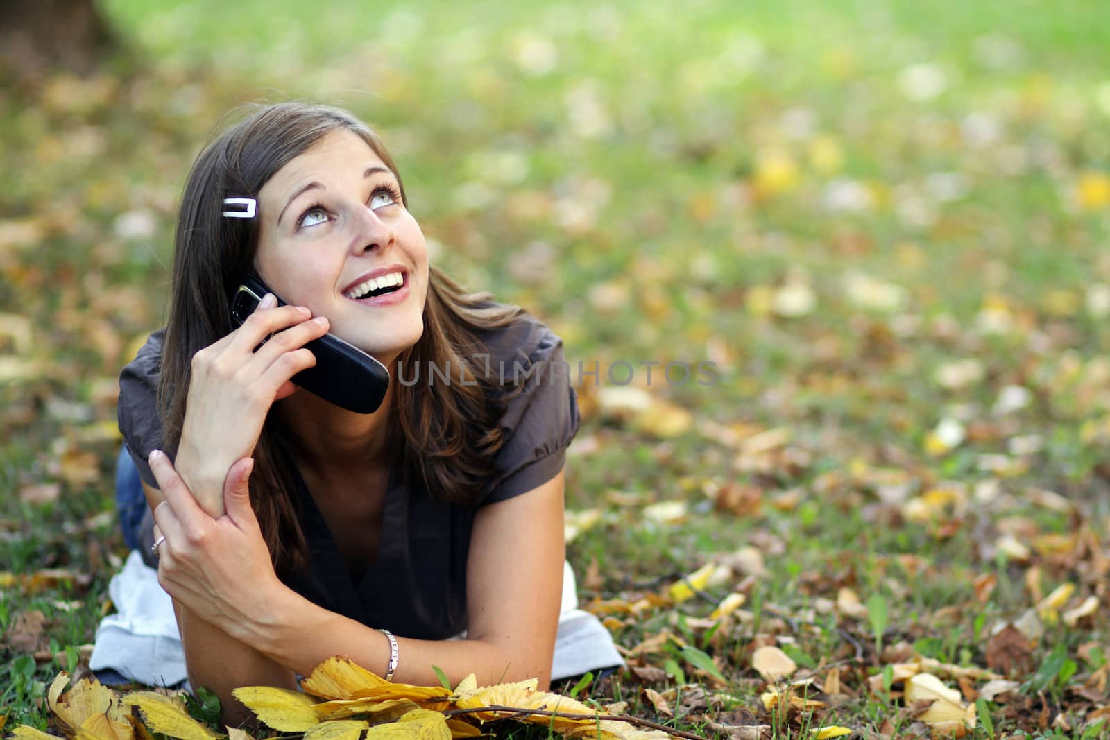 woman calling by phone in autumn park