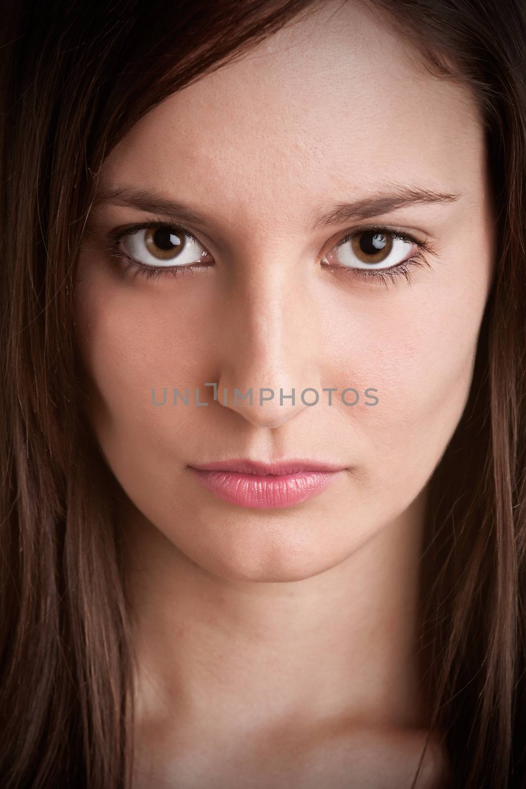 Angry girl looking mean in a dark room