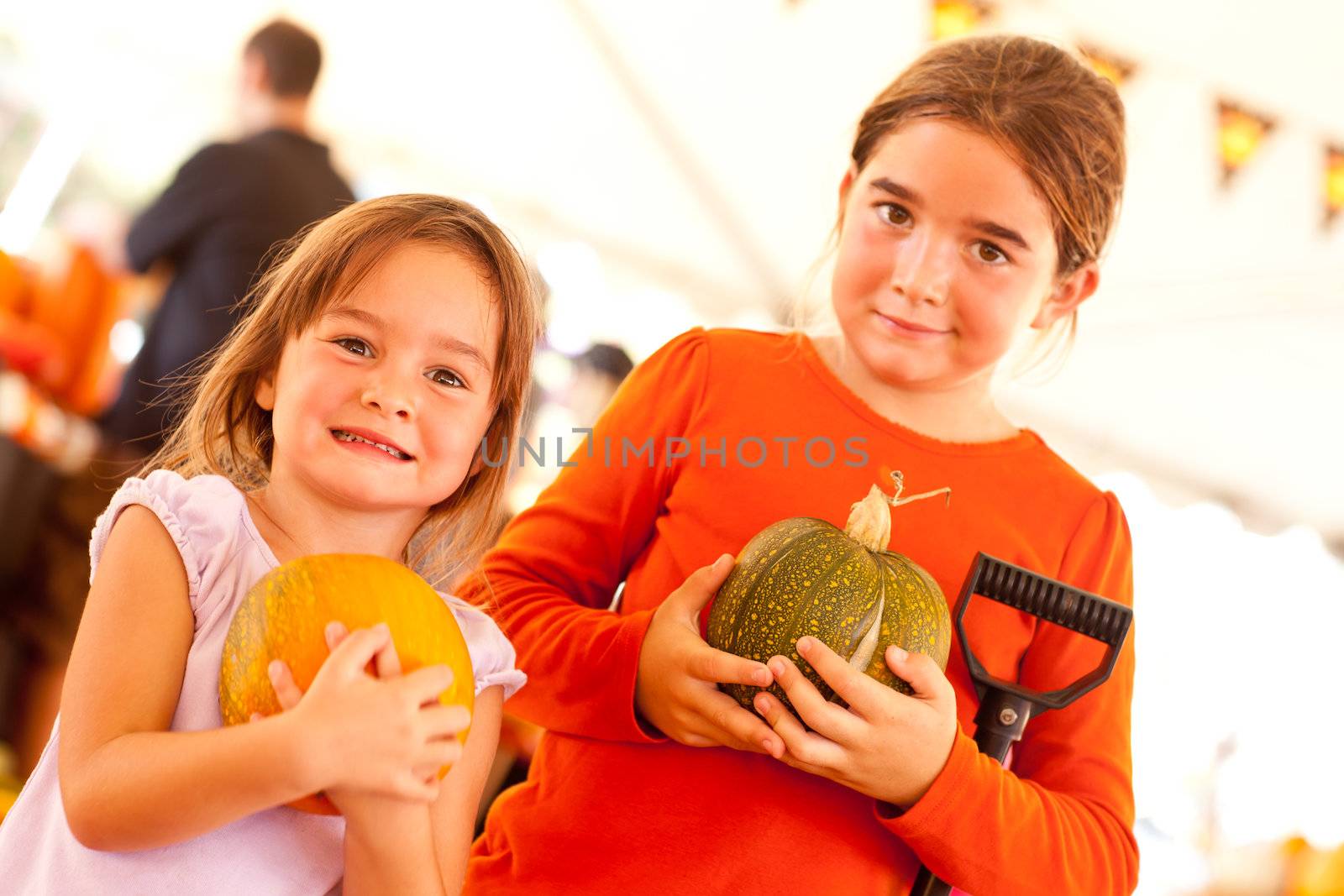Cute Little Girls Holding Their Pumpkins At A Pumpkin Patch by Feverpitched
