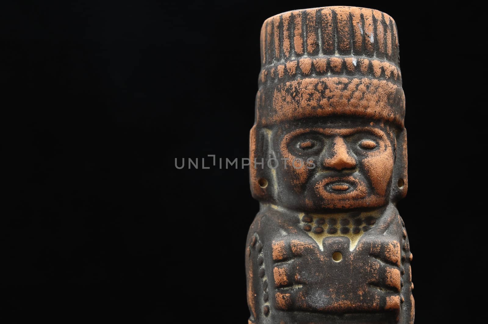 One Ancient Mayan Statue on a Black Background