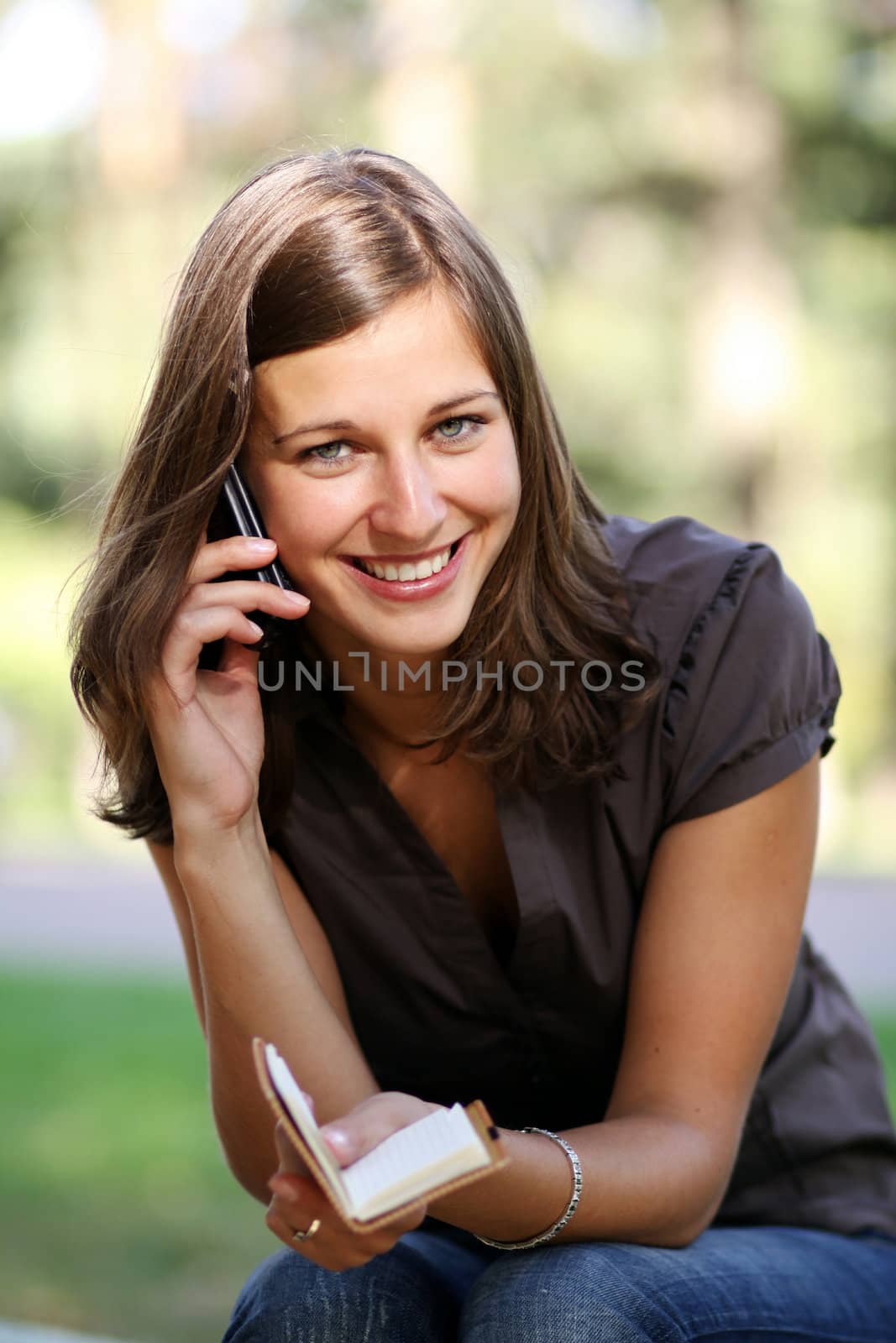 Young beautiful woman talking on cell phone