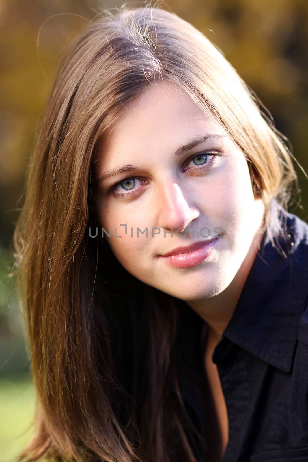 Beautiful young woman in autumn park