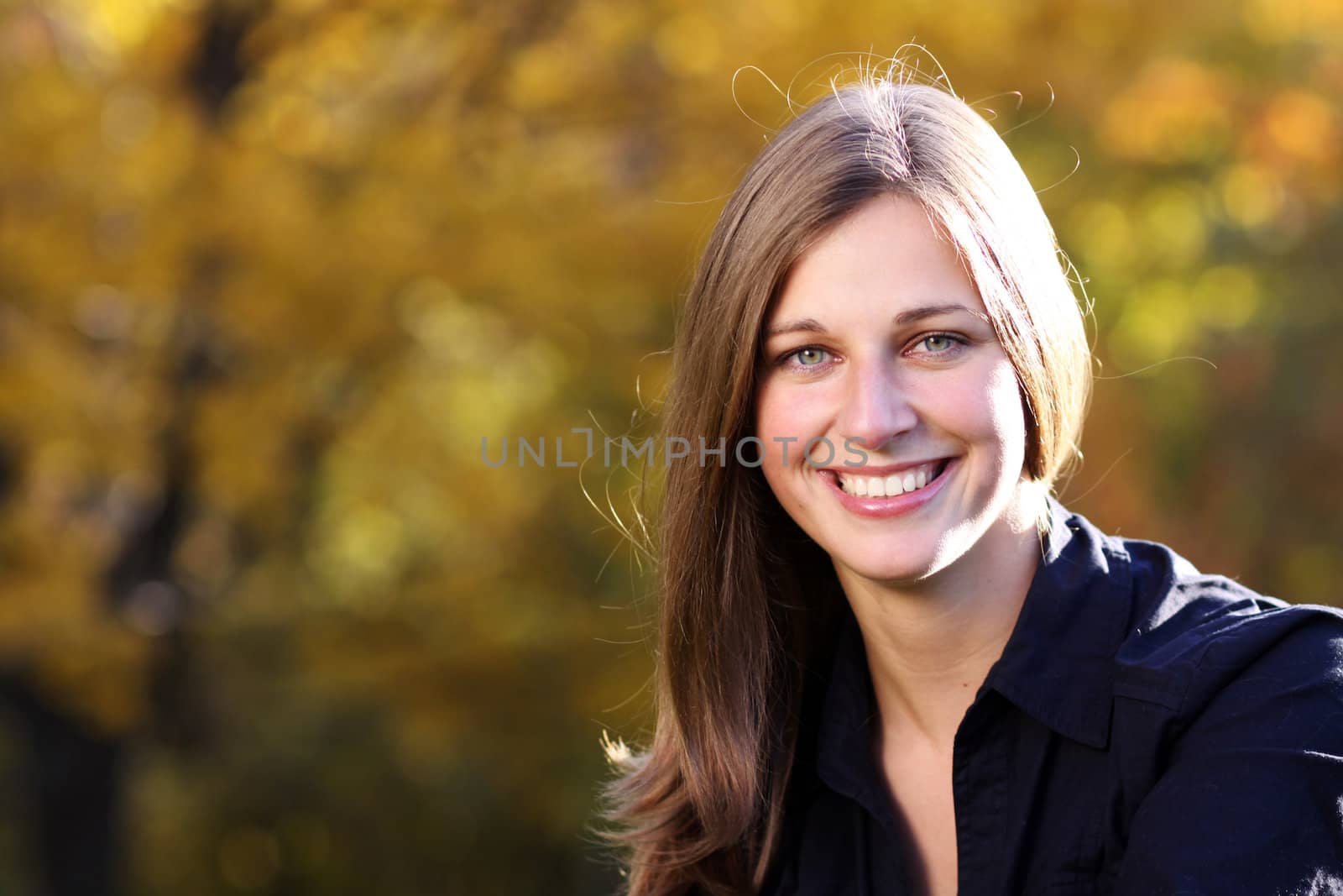Beautiful young woman in autumn park