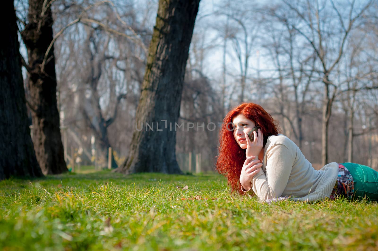 beautiful young woman on the phone in the park